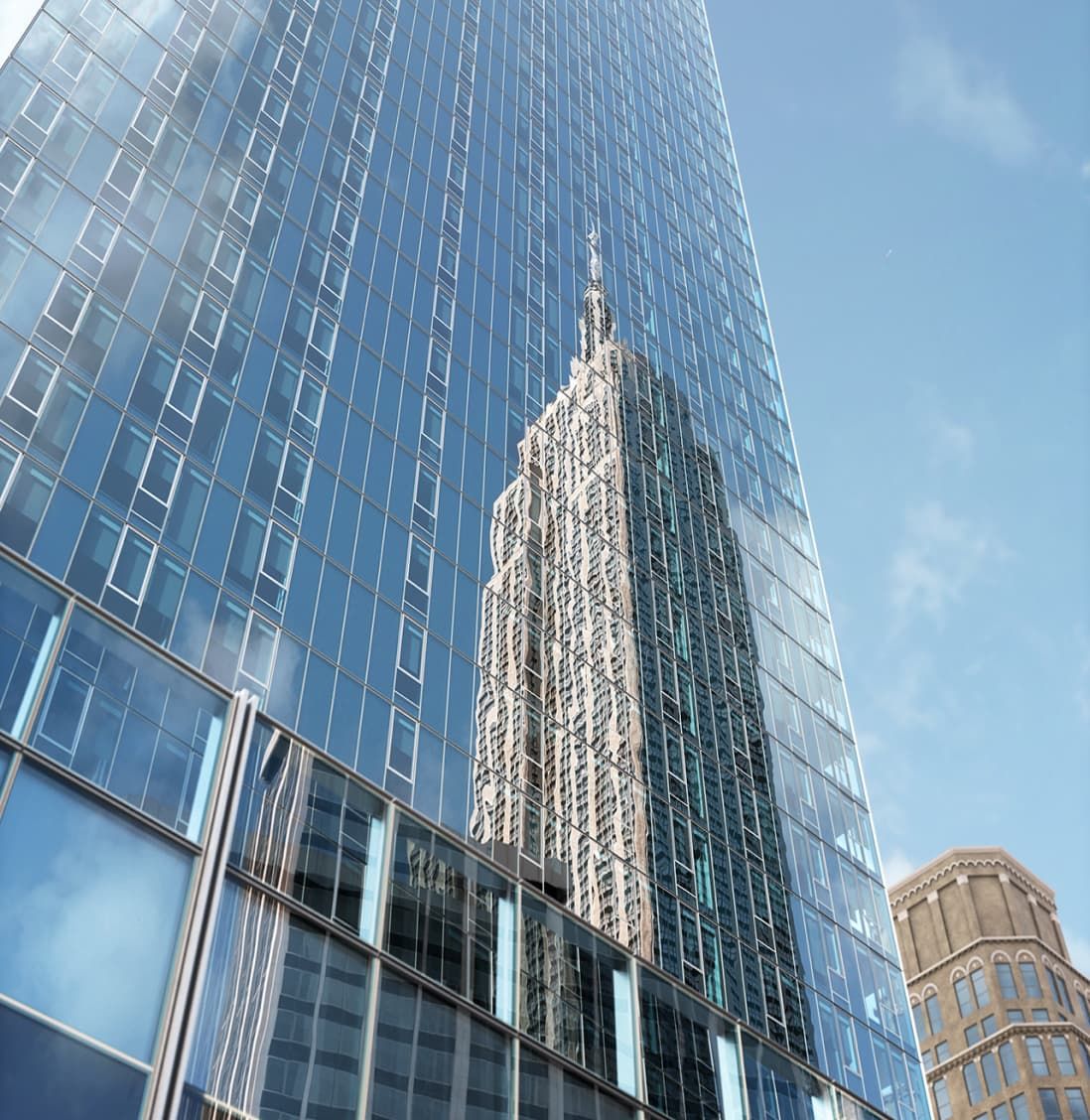 Reflection of the Empire State Building visible in the glass facade of EOS, a nearby residential skyscraper.