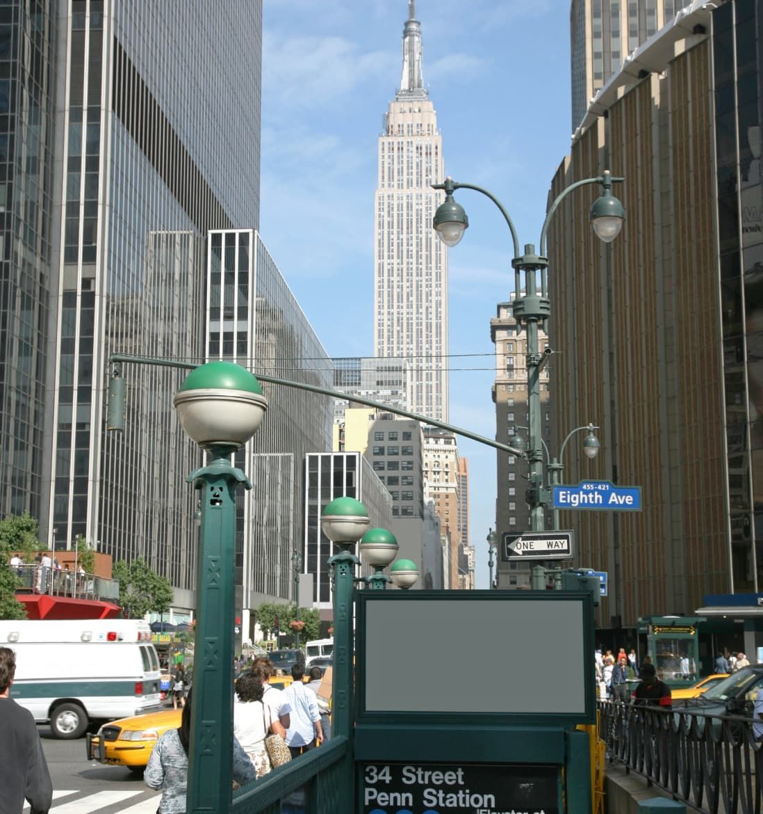 A subway station entrance, with towering skyscrapers visible in the background.